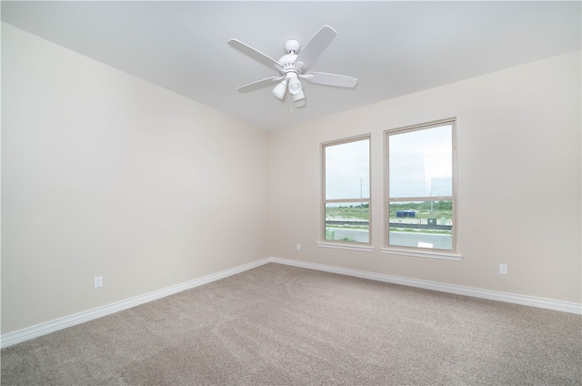 spare room featuring carpet flooring and ceiling fan