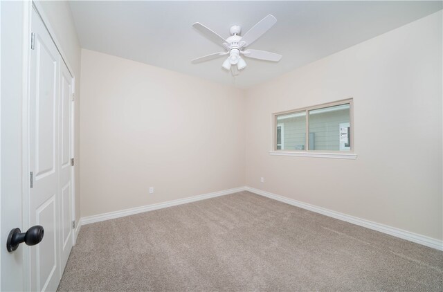 spare room featuring ceiling fan and carpet floors