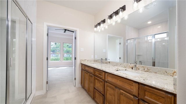 bathroom featuring ceiling fan, a shower with door, and vanity