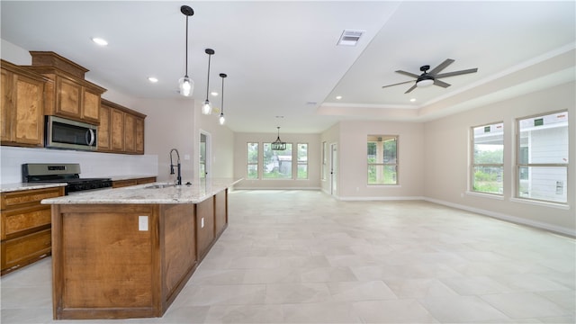 kitchen featuring pendant lighting, a large island, a healthy amount of sunlight, and stainless steel appliances