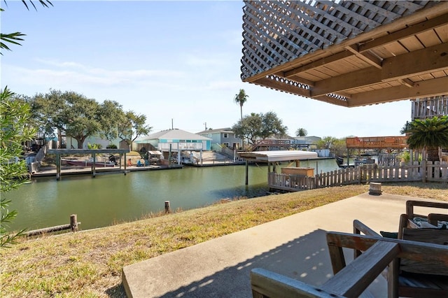 view of patio featuring a water view and a dock