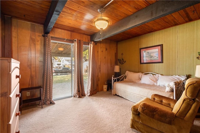 carpeted bedroom with beamed ceiling, wooden ceiling, access to exterior, and wood walls