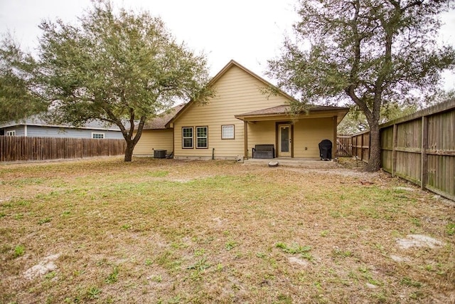 2421 Country Oaks Cir, Ingleside, TX 78362 - back of property featuring cooling unit, a fenced backyard, and a yard