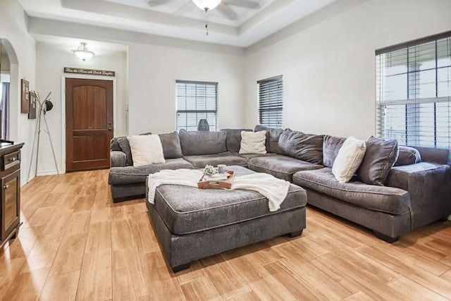 2421 Country Oaks Cir, Ingleside, TX 78362 - living area with arched walkways, a raised ceiling, a ceiling fan, a towering ceiling, and light wood-type flooring