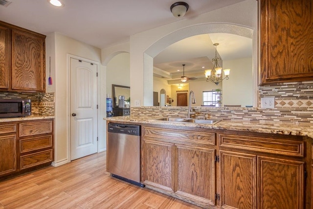 2421 Country Oaks Cir, Ingleside, TX 78362 - kitchen with dishwasher, light wood finished floors, a sink, and light stone countertops