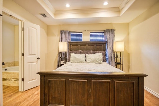 2421 Country Oaks Cir, Ingleside, TX 78362 - bedroom with light wood-style floors, visible vents, a tray ceiling, and ornamental molding