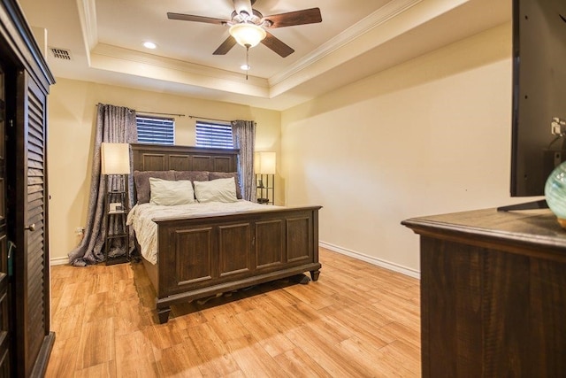 2421 Country Oaks Cir, Ingleside, TX 78362 - bedroom with ornamental molding, a raised ceiling, light wood-style flooring, and baseboards