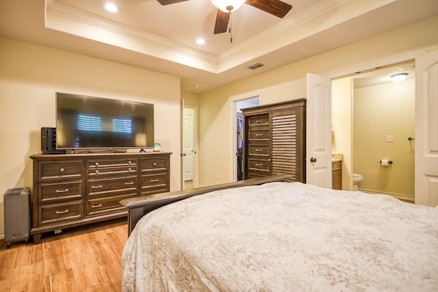 2421 Country Oaks Cir, Ingleside, TX 78362 - bedroom featuring light wood finished floors, visible vents, a raised ceiling, and ornamental molding