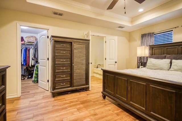 2421 Country Oaks Cir, Ingleside, TX 78362 - bedroom featuring ornamental molding, a tray ceiling, light wood-type flooring, and visible vents