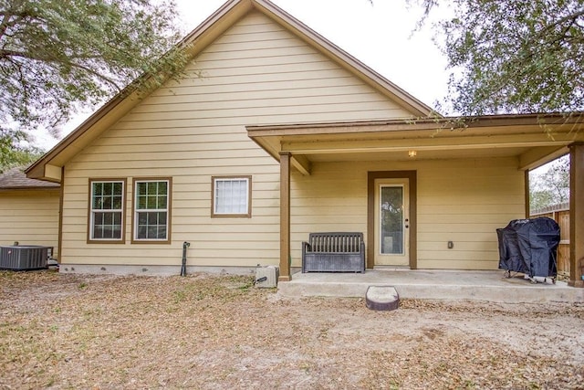 2421 Country Oaks Cir, Ingleside, TX 78362 - rear view of house featuring central AC unit and a patio