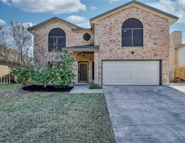 view of front of property with a garage and a front yard