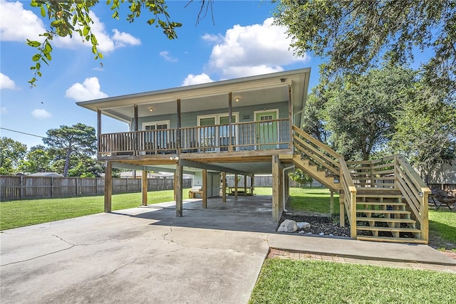 rear view of property featuring a lawn and a carport