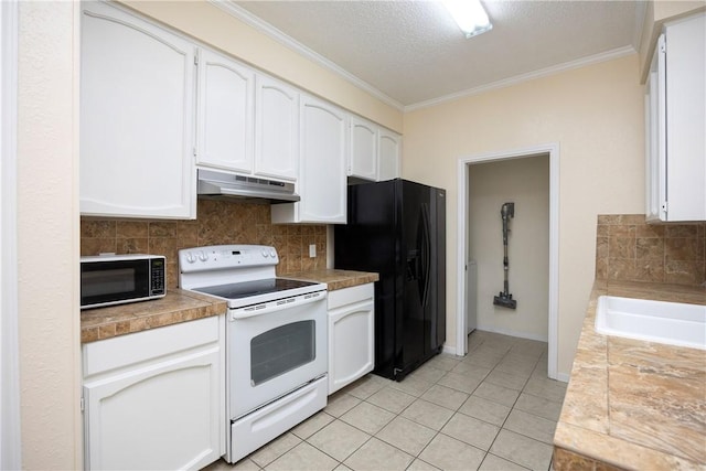 kitchen with tile countertops, black appliances, white cabinets, ornamental molding, and light tile patterned floors