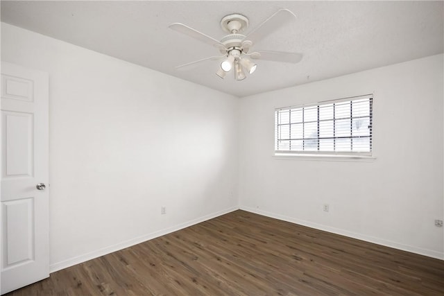 spare room featuring ceiling fan and dark hardwood / wood-style flooring