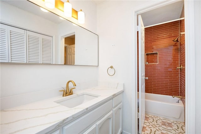 bathroom featuring tile patterned floors, vanity, and tiled shower / bath