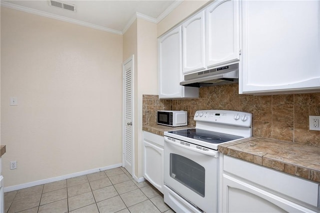 kitchen featuring light tile patterned floors, white appliances, white cabinetry, and ornamental molding