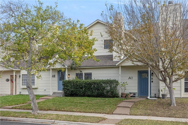 obstructed view of property featuring a front yard