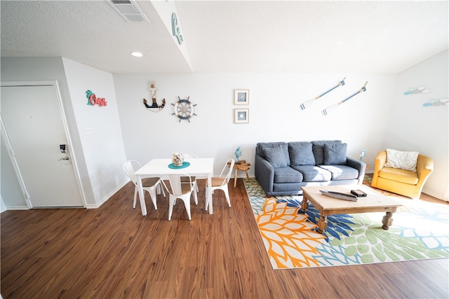 dining area featuring hardwood / wood-style floors and a textured ceiling