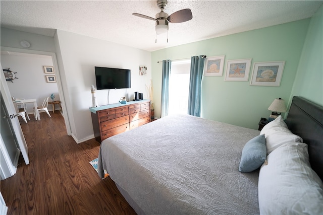 bedroom featuring a textured ceiling, ceiling fan, and dark hardwood / wood-style floors