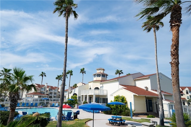 view of building exterior featuring a community pool