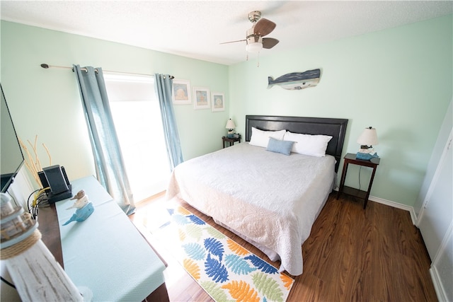 bedroom with ceiling fan and dark hardwood / wood-style floors