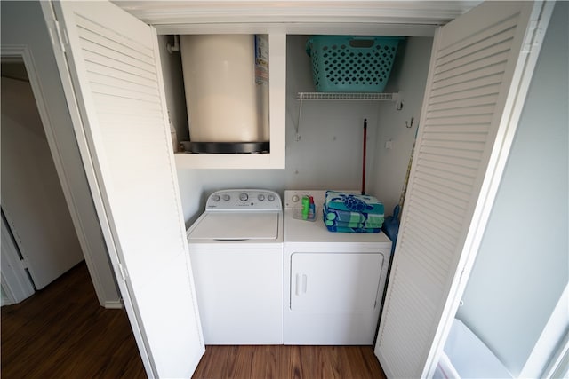 laundry room featuring dark hardwood / wood-style floors and washer and clothes dryer