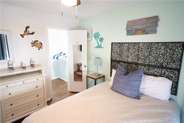 bedroom with hardwood / wood-style floors and a textured ceiling