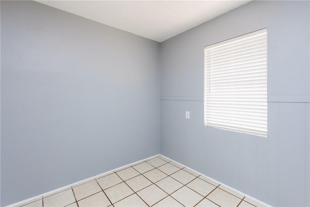 empty room featuring wainscoting