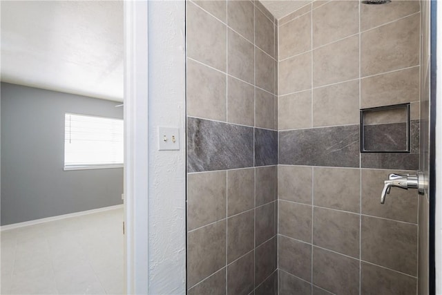 full bathroom with baseboards and a stall shower