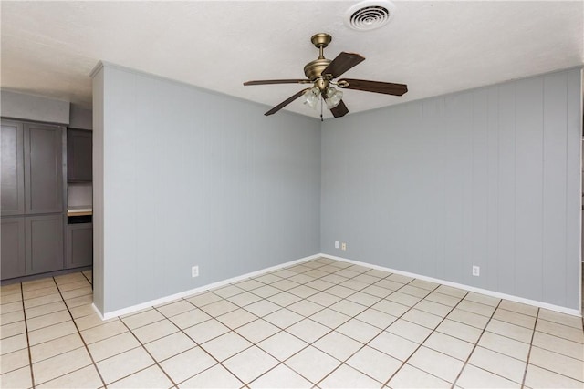 unfurnished room with light tile patterned floors, visible vents, and ceiling fan