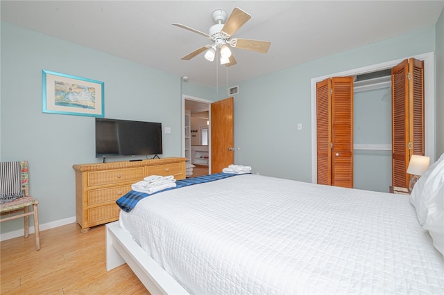 bedroom with hardwood / wood-style flooring, ceiling fan, and a closet