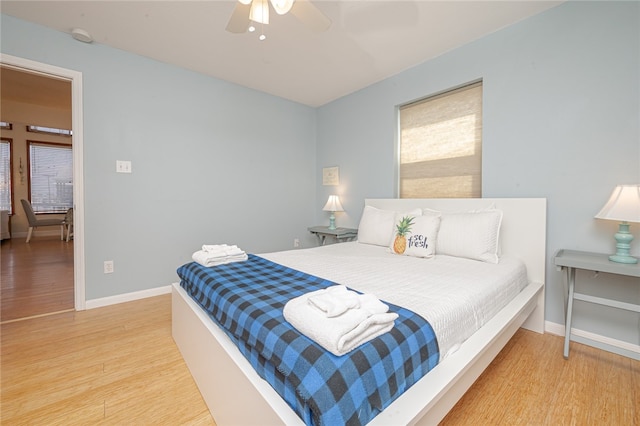 bedroom with ceiling fan and wood-type flooring