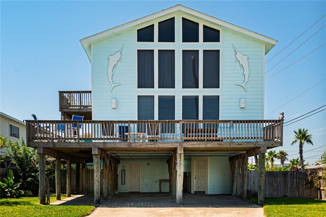 back of house with a carport and a wooden deck