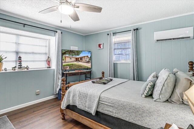 1032 Illinois St, Robstown, TX 78380 - bedroom with a wall mounted air conditioner, wood finished floors, ornamental molding, a textured ceiling, and a ceiling fan