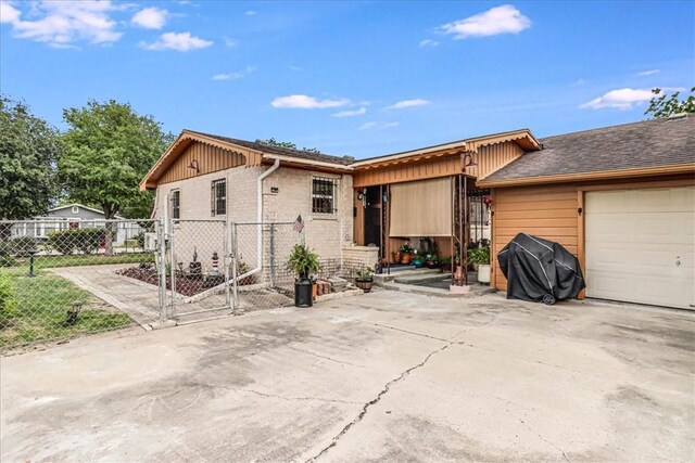 1032 Illinois St, Robstown, TX 78380 - view of front of house featuring an attached garage, a gate, and concrete driveway