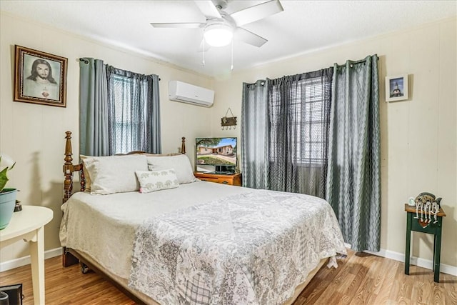 1032 Illinois St, Robstown, TX 78380 - bedroom with an AC wall unit, wood finished floors, and ceiling fan
