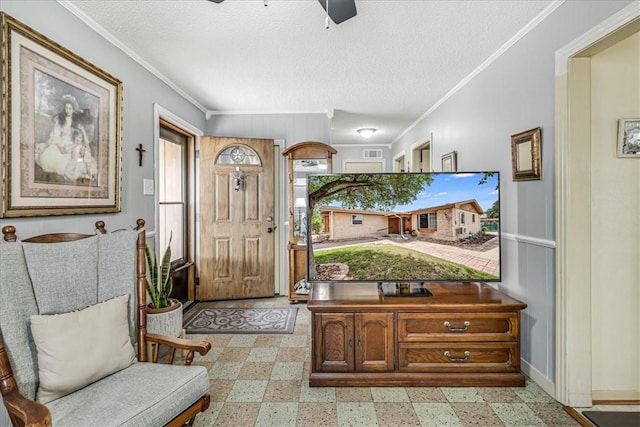 1032 Illinois St, Robstown, TX 78380 - foyer with ornamental molding, ceiling fan, light floors, and a textured ceiling