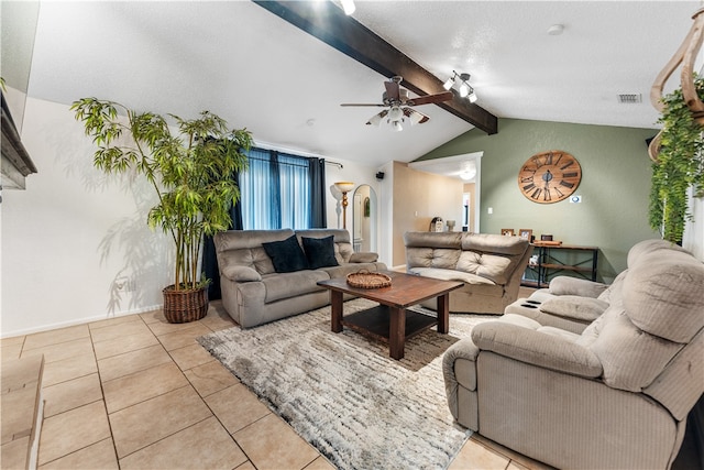 living room featuring a textured ceiling, vaulted ceiling with beams, ceiling fan, and light tile patterned floors