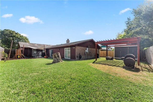 rear view of property with a playground, a pergola, and a yard