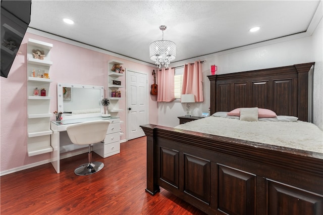 bedroom featuring a textured ceiling, a notable chandelier, and dark hardwood / wood-style floors