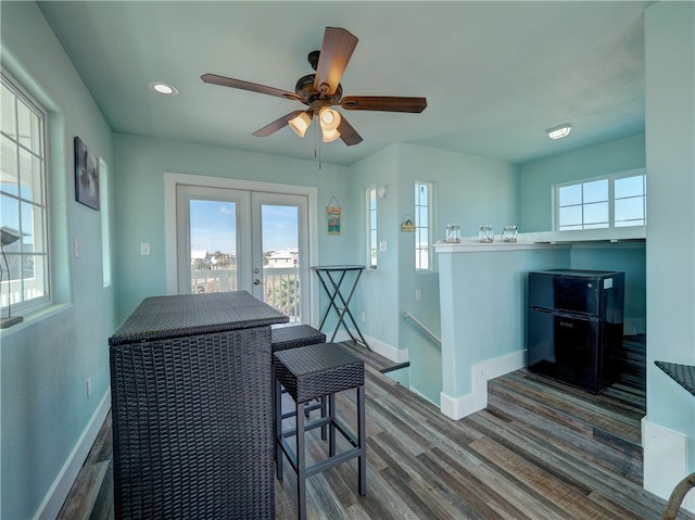 dining room with french doors, plenty of natural light, and wood-type flooring