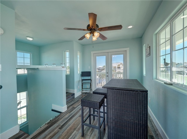 dining room featuring ceiling fan, dark hardwood / wood-style floors, and french doors