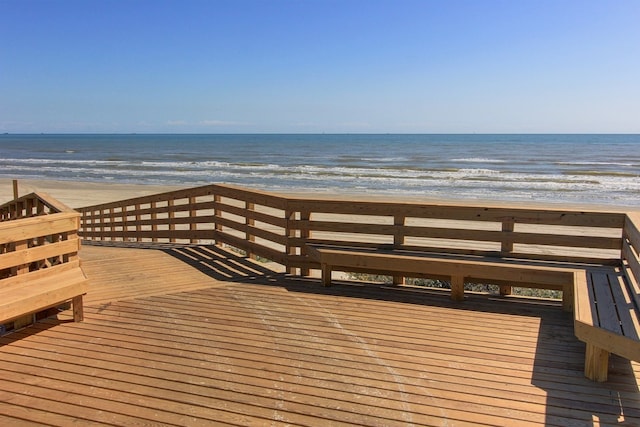 surrounding community with a water view and a view of the beach