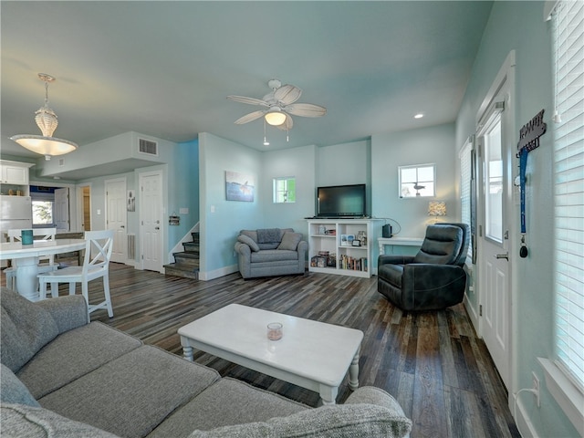 living room with ceiling fan, plenty of natural light, and dark hardwood / wood-style flooring