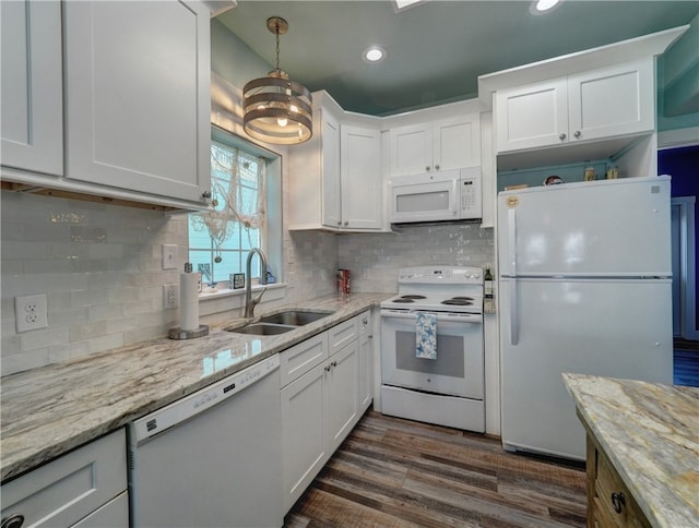 kitchen with dark hardwood / wood-style flooring, white appliances, sink, and white cabinets