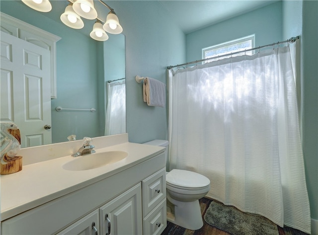 bathroom featuring hardwood / wood-style floors, curtained shower, vanity, and toilet