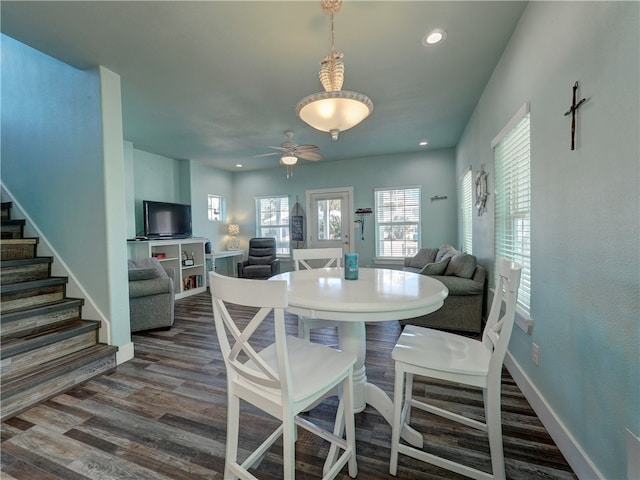 dining space featuring dark hardwood / wood-style flooring and ceiling fan