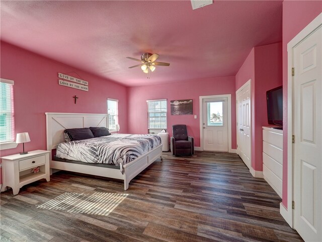 bedroom with ceiling fan and dark hardwood / wood-style floors