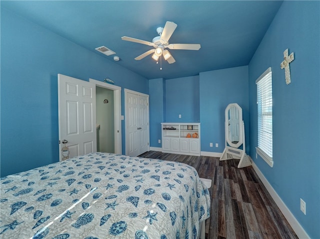 bedroom with ceiling fan and dark hardwood / wood-style floors