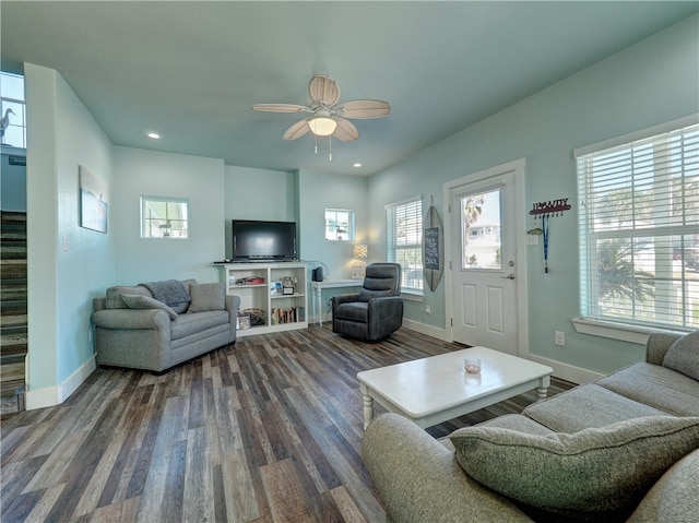 living room with a wealth of natural light, ceiling fan, and dark hardwood / wood-style flooring